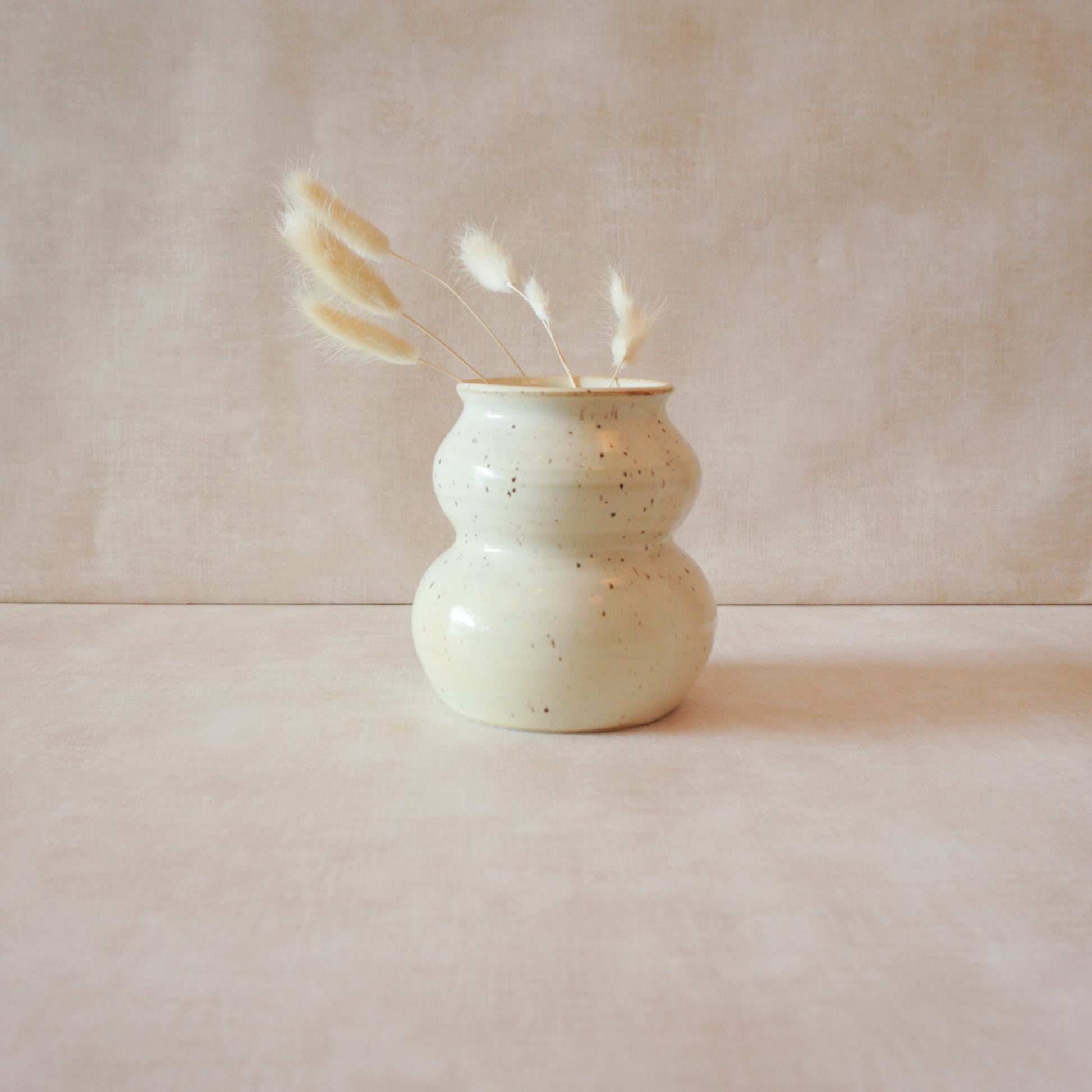 Handcrafted cream speckled vase with understated style