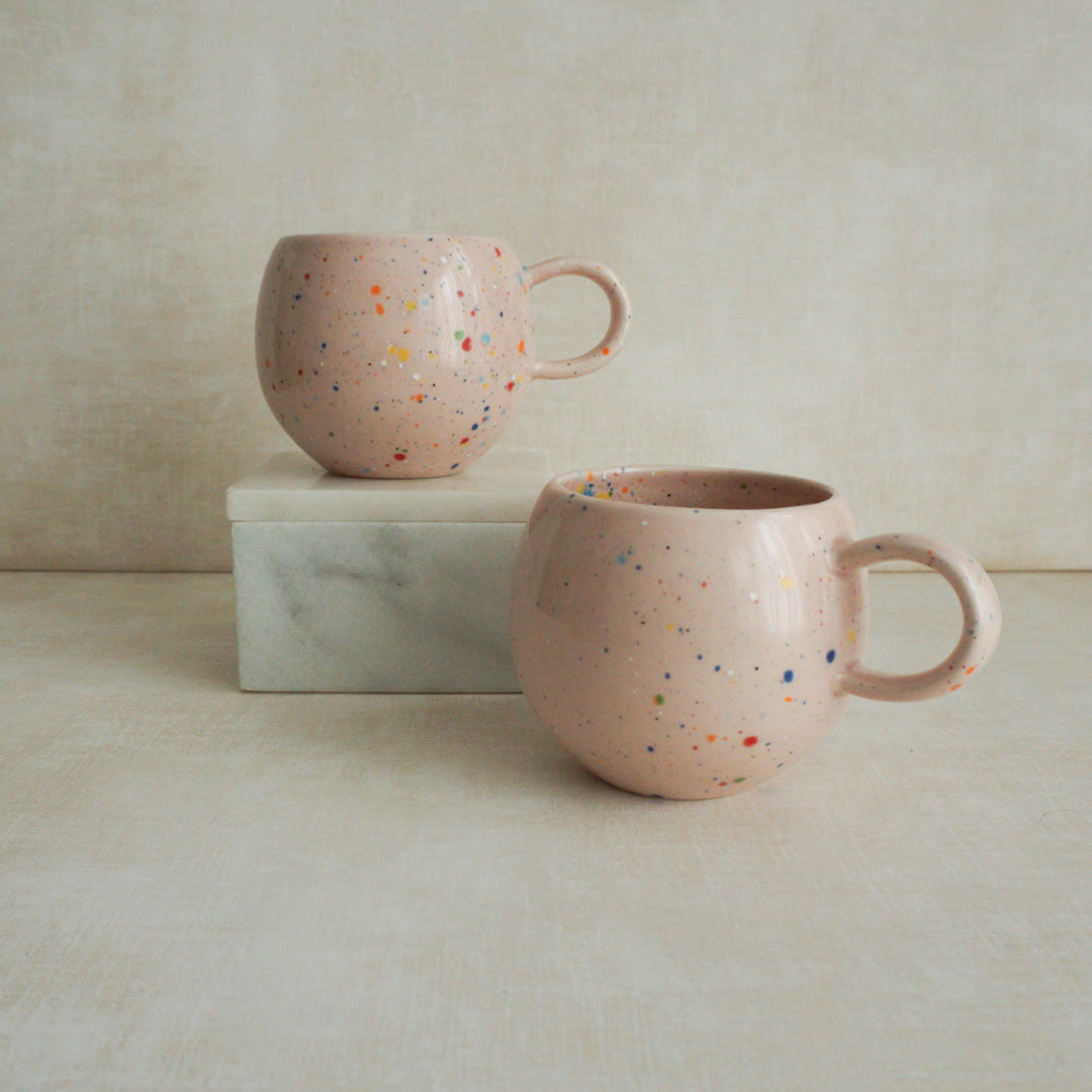 Whimsical ball-shaped mug adorned with pink confetti